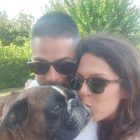 a man and woman taking a selfie with a dog